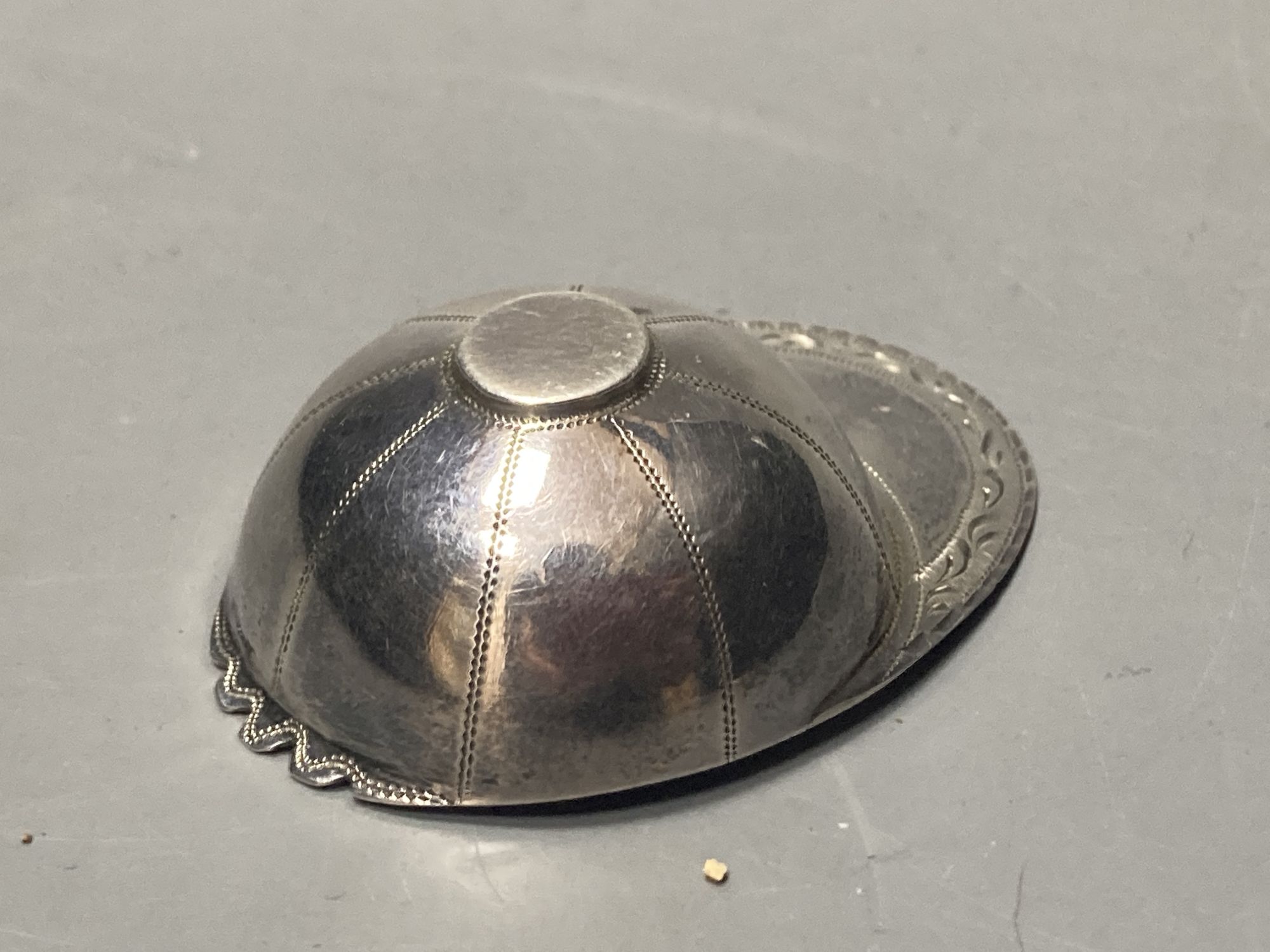 A George III engraved silver novelty caddy spoon, modelled as a jockeys cap, Josiah Snatt, London, 1810, 51mm.